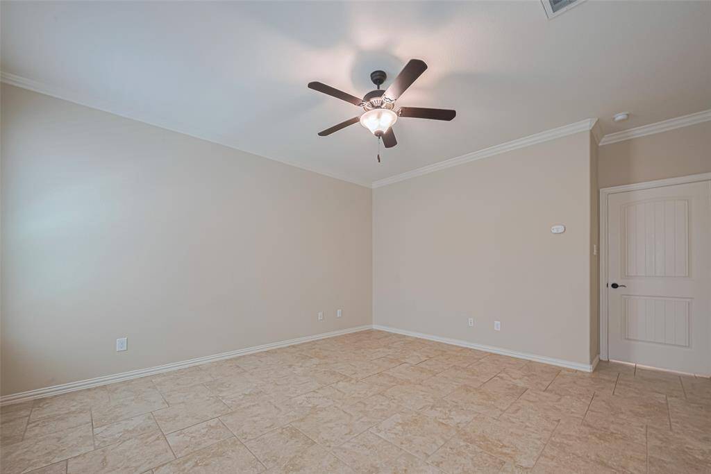Soft neutrals and warm tile flooring create a calming retreat, perfect for winding down after a long day.