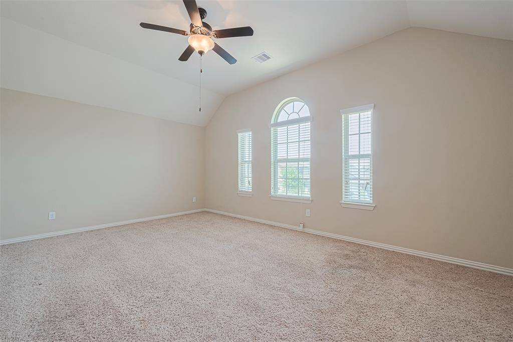 This expansive upstairs game room offers endless possibilities, with plush carpeting, sloping ceilings, and plenty of room to spread out.
