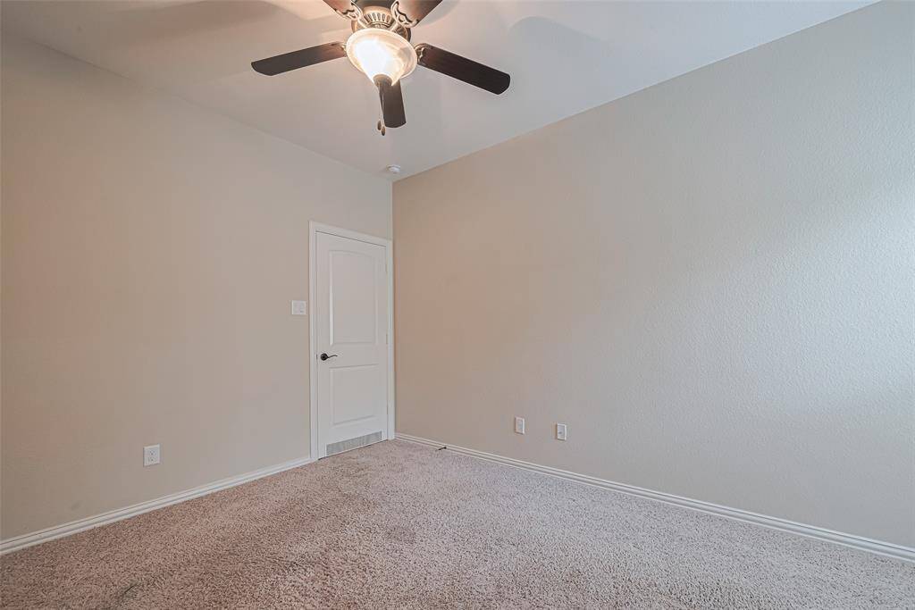 Seen from another angle, the room’s calm color palette, ceiling fan, and convenient layout enhance its comfort.