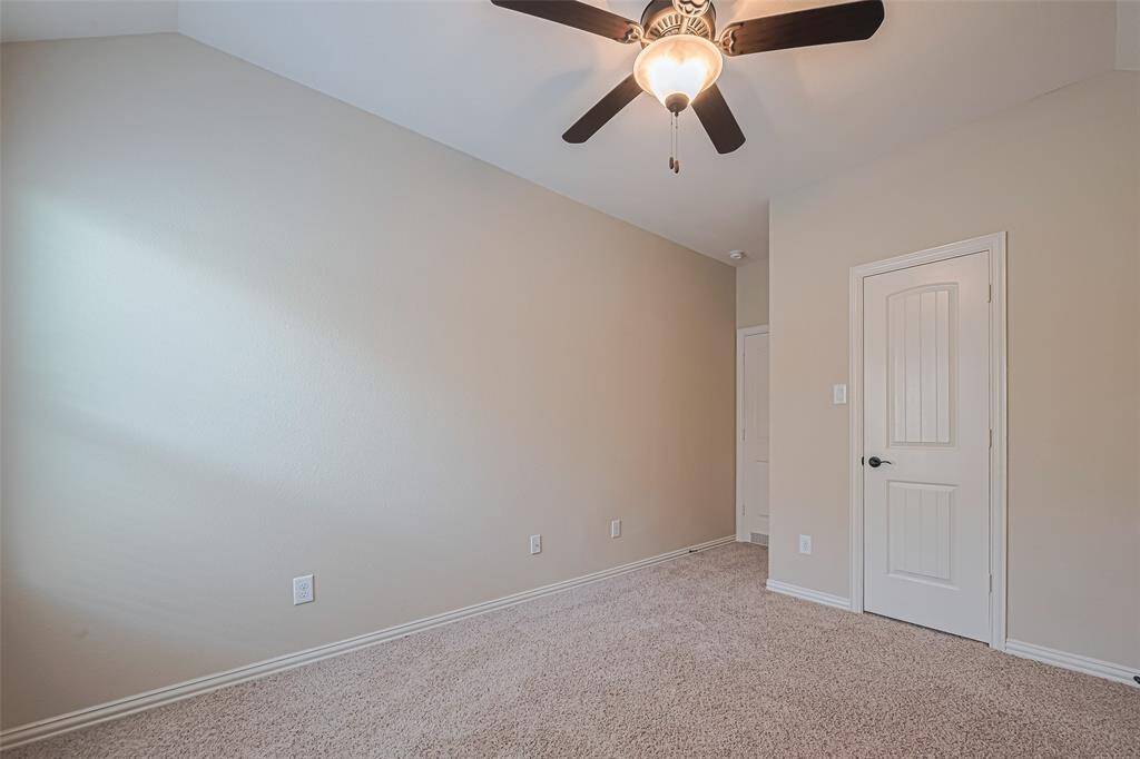 From the opposite side, the closet and entry door are in view, giving a sense of the room’s layout and flow.