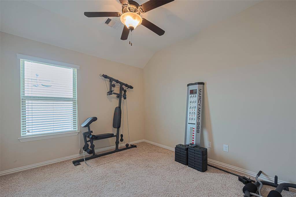 Whether used as a guest room, office, or fitness space, this fourth bedroom is full of potential, with generous light and soft carpeting.
