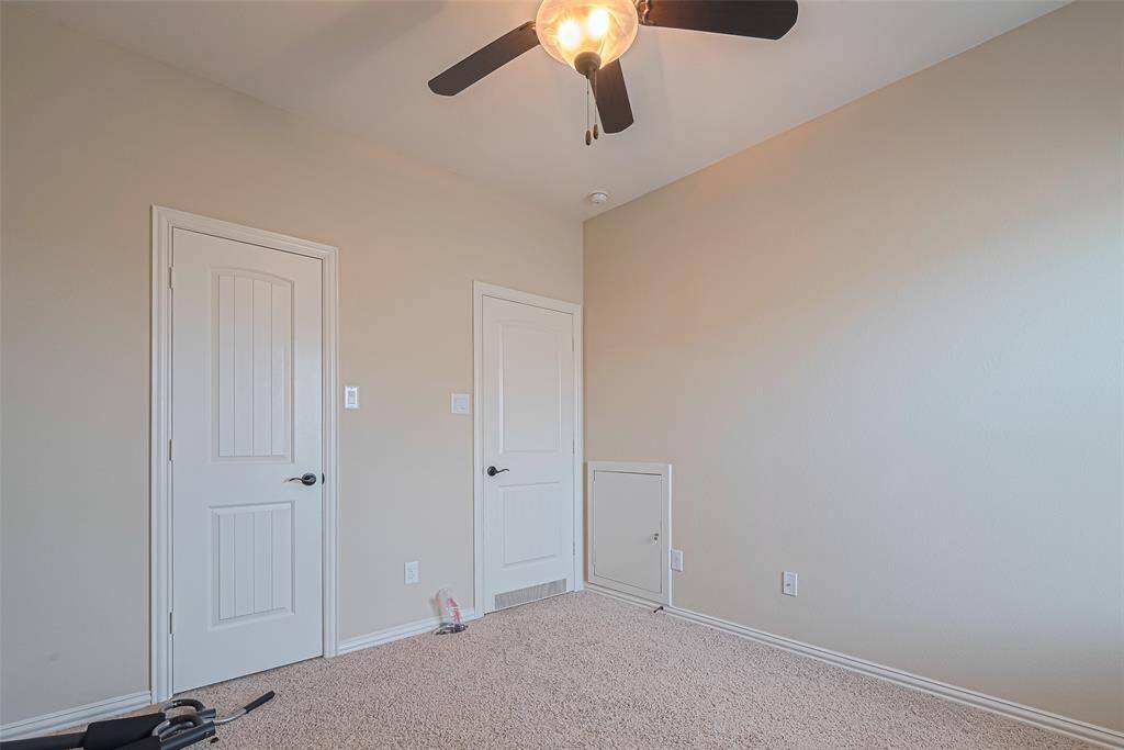 A closer look reveals the room’s thoughtful setup, with both closet and entry doors tucked side by side for efficiency.
