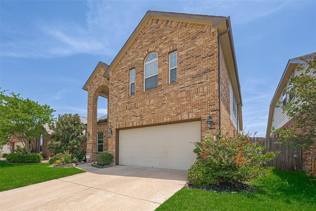 This side view of the front exterior reveals the brick’s varied tones, bringing depth and timeless charm to the curb appeal.