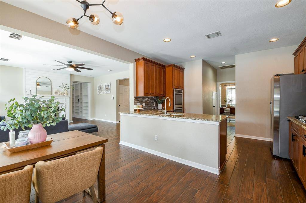 The kitchen features generous seating space, perfect for casual dining, homework, or entertaining guests.