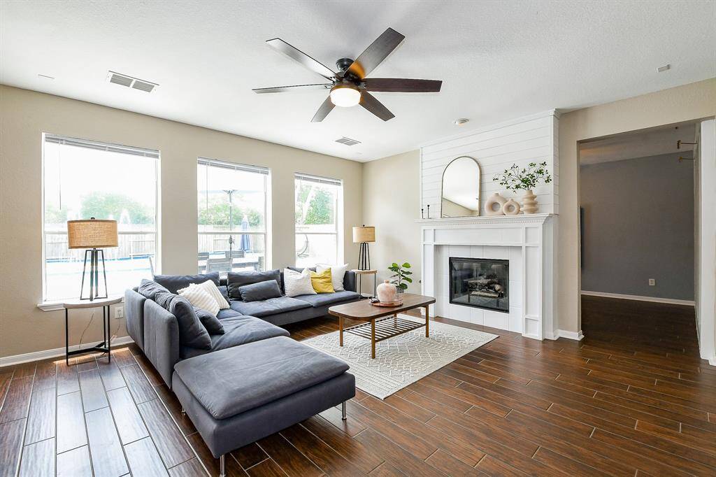 Featuring a warm and inviting family room centered around a stunning double-sided fireplace, perfect for cozy gatherings.