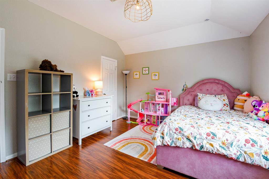 Wake up to peaceful views in this charming bedroom overlooking the backyard.