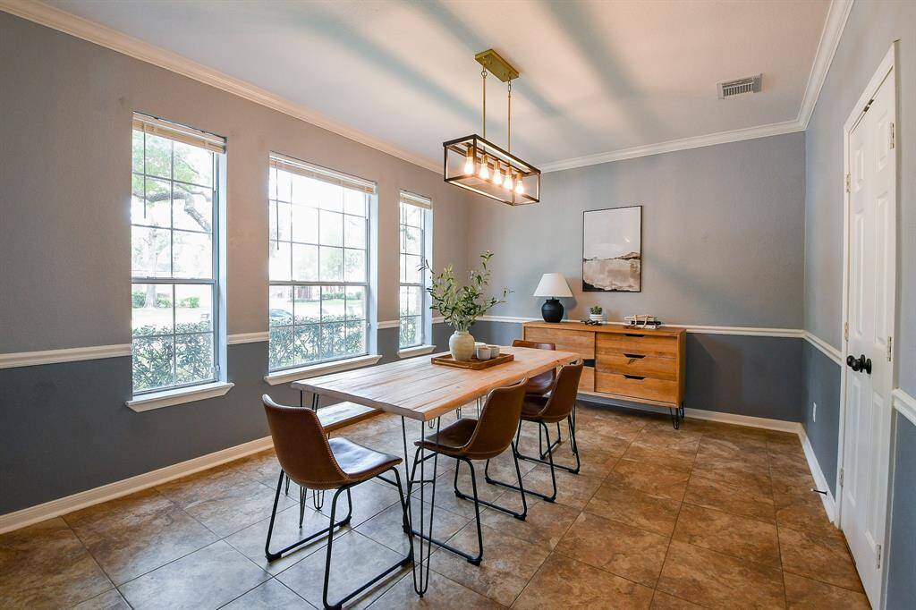 Natural light pours into the formal dining area, creating a bright and uplifting atmosphere.