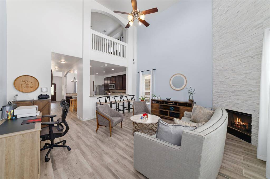 The gas log fireplace with modern accent wall make the house looks so much cozy.