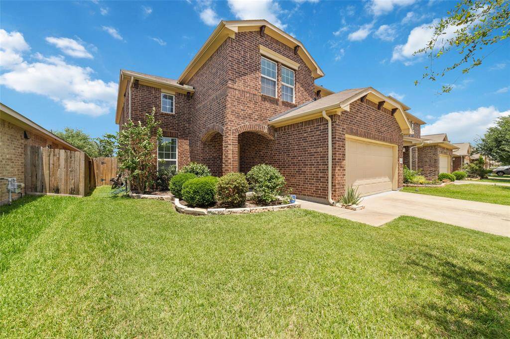 Another front view highlights beautiful brick structure of the house.