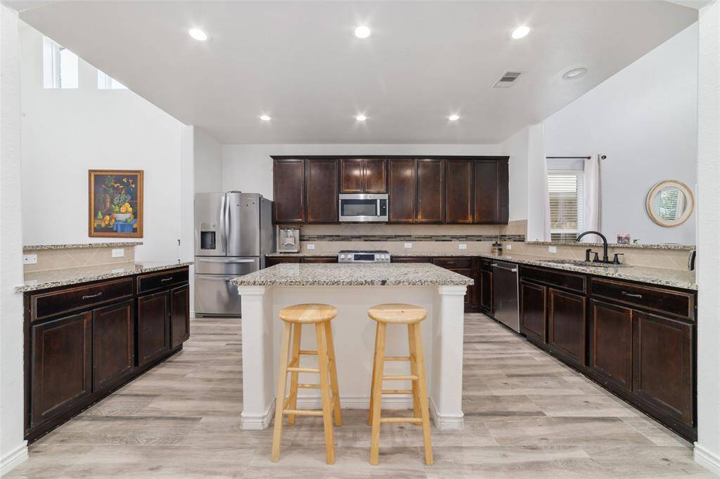 Kitchen looks clean, neat and modern with ceiling lights feature.