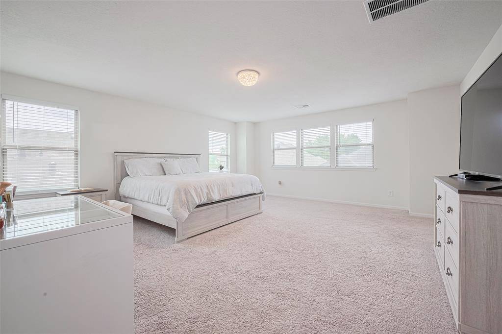 Huge primary bedroom upstairs with a large walk in closet