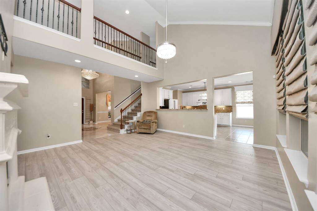 Bathed in natural light from two levels of expansive high ceilings, this spacious living area exudes brightness, openness, and refined elegance.