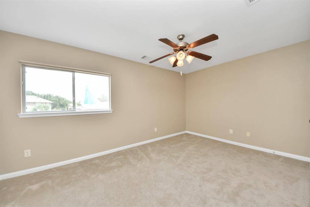 This tranquil bedroom serves as a peaceful retreat, adorned with soft neutral tones that enhance its calming ambiance.