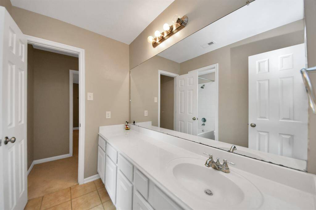 This inviting shared bathroom offers both privacy and charm, perfect for relaxation or for daily routine.