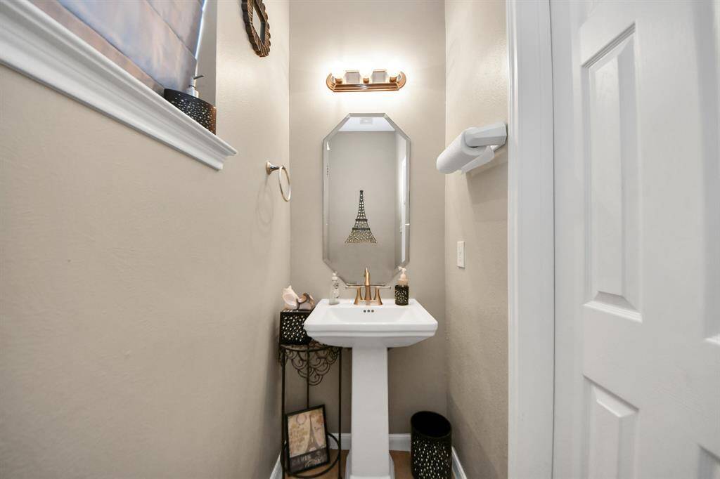 This powder room exudes charm; it blends classic with a touch of modern design.
