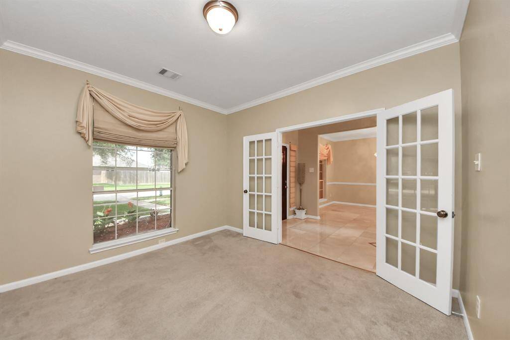 This office/studio area is located at the entrance of the home. A glimpse of the elegant double doors reinforces the seamless flow of the space.