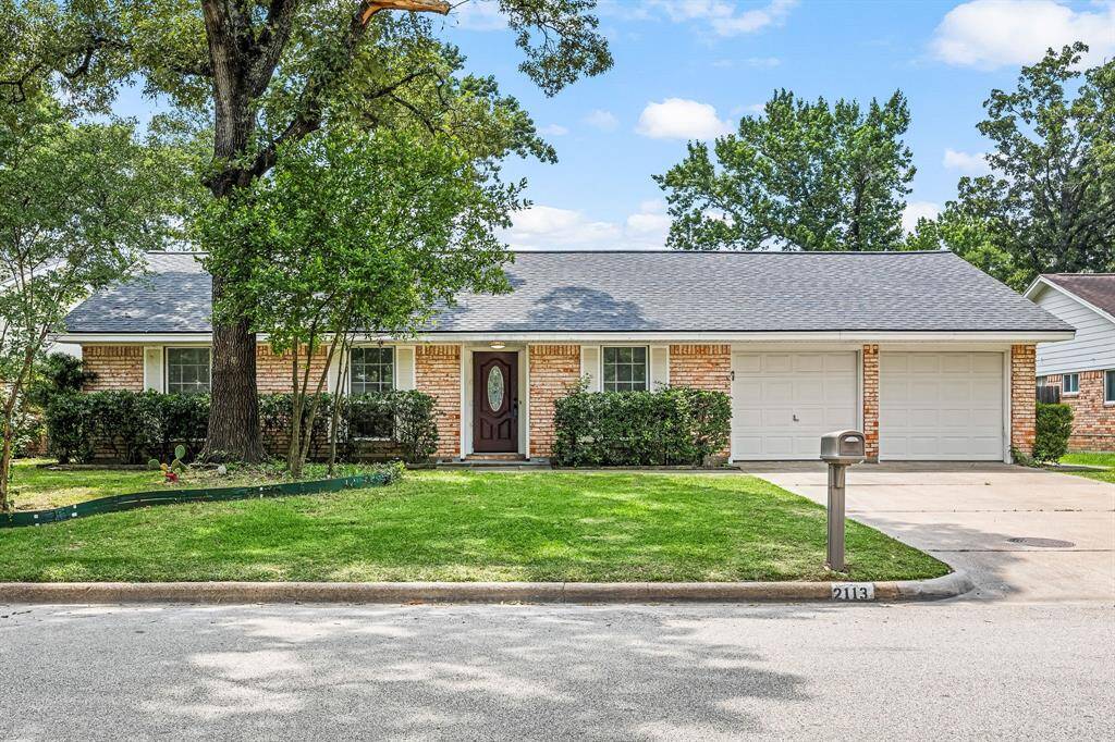 This charming single-story brick home features a well-maintained front yard with mature trees, a welcoming front entrance, and a two-car garage. It's nestled in a quiet neighborhood, perfect for families.