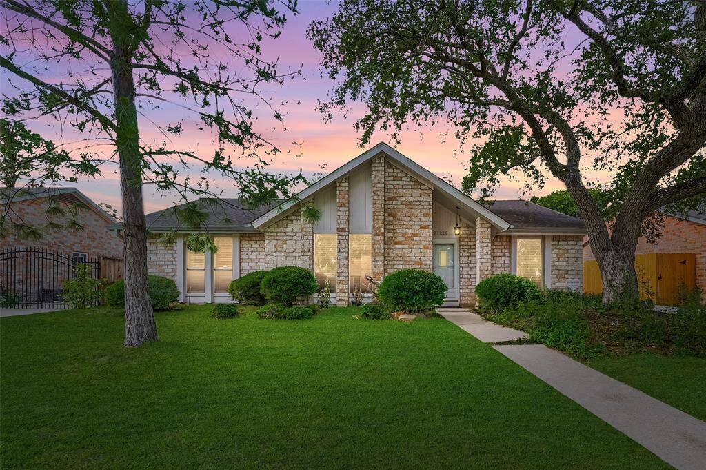 Charming curb appeal meets classic Texas stone! This inviting single-story home features mature trees, manicured shrubs, and a welcoming walkway leading to a cozy front porch.