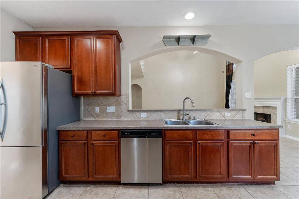 Stainless appliances(fridge stays) and recessed lighting.