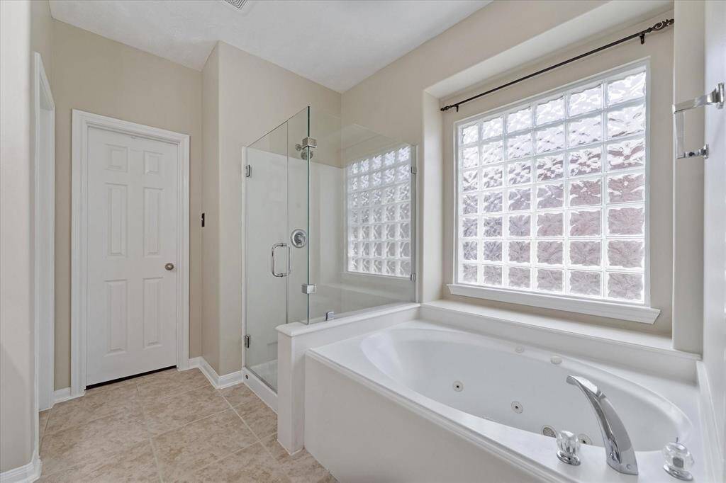 Another view of the Primary Bath. The door leads to a large walk in closet.