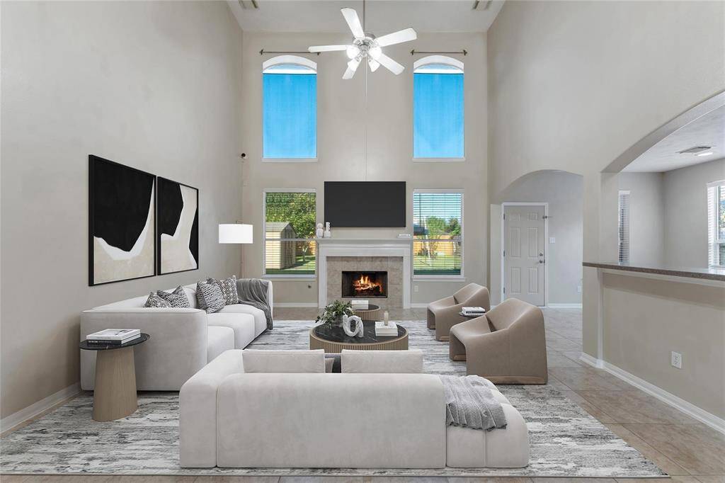 Soaring Ceilings and Gas Fireplace grace the two story Family Room.