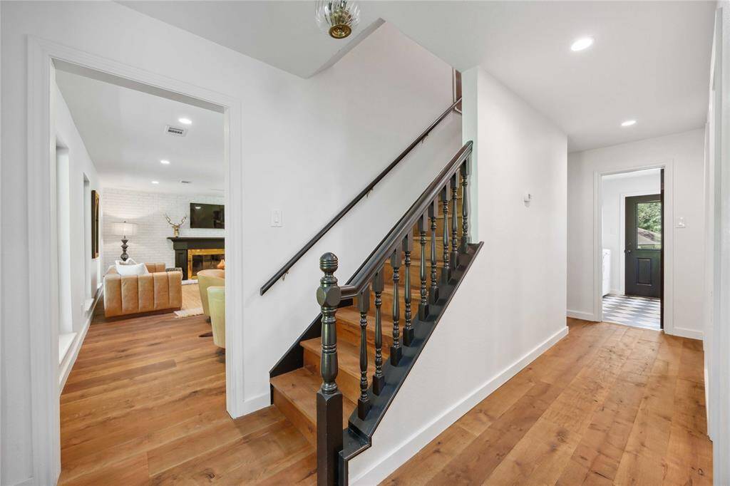 Located behind the stairs is the entry to the indoor laundry room.