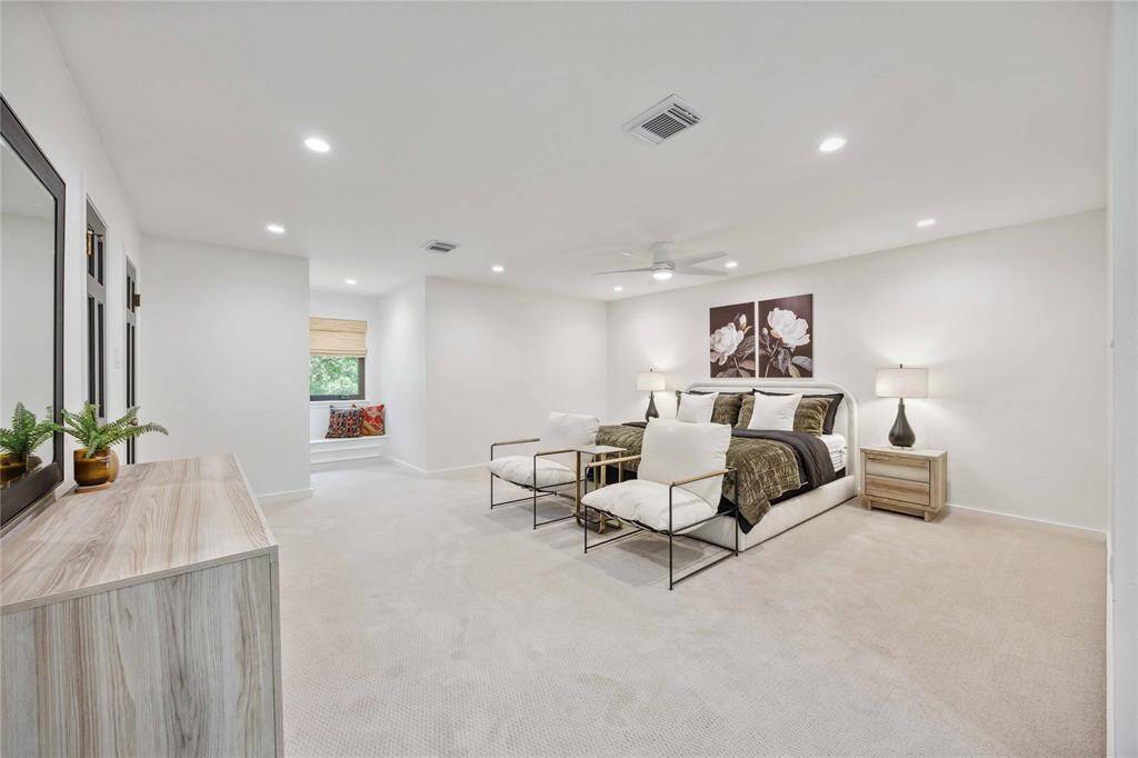 Indulge in unbelievable space in this primary retreat! A high ceiling with recessed lighting, new carpet, and a dreamy window seat make up this desirable suite.
