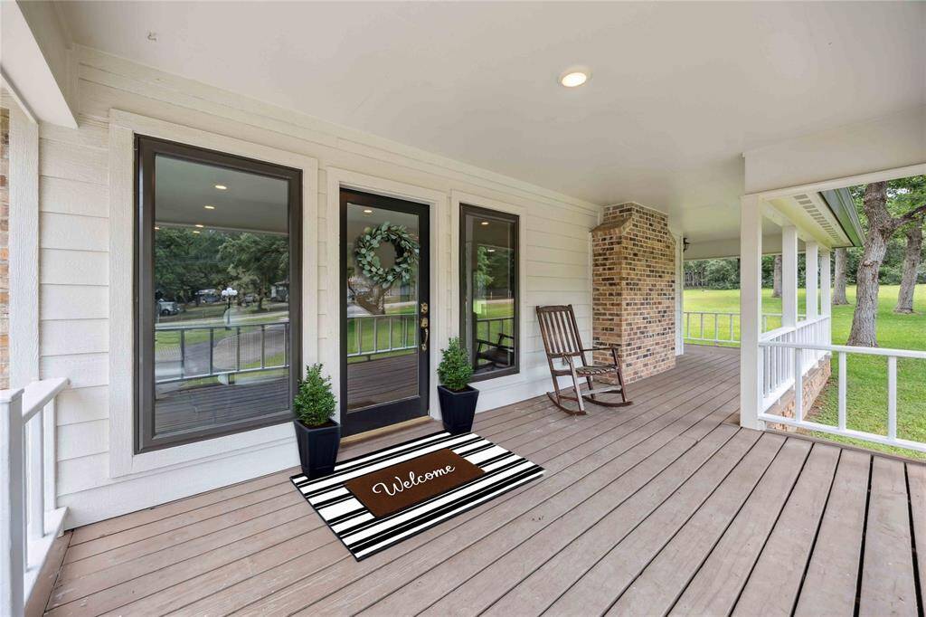 Brand new siding, fresh exterior paint, and gorgeous black-framed picture windows really stand out on this amazing wrap-around porch.