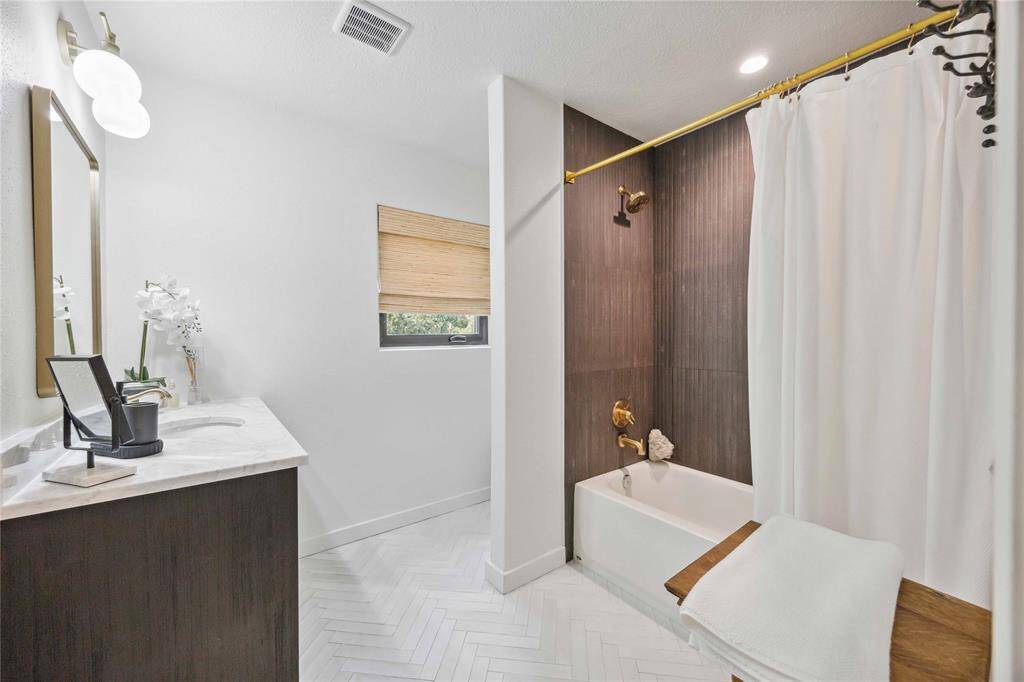 A beautiful 3rd full bath on the 2nd floor features a tub and shower combination.