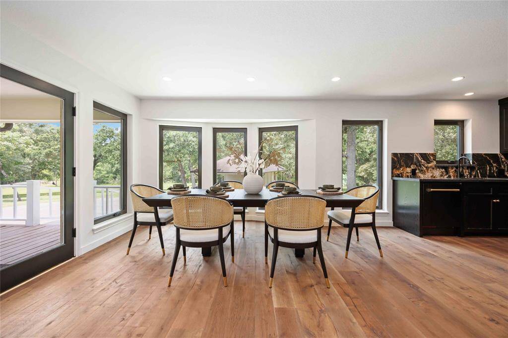The gorgeous hardwood floors join the kitchen, living room, and dining room to offer an ideal home for large gatherings.