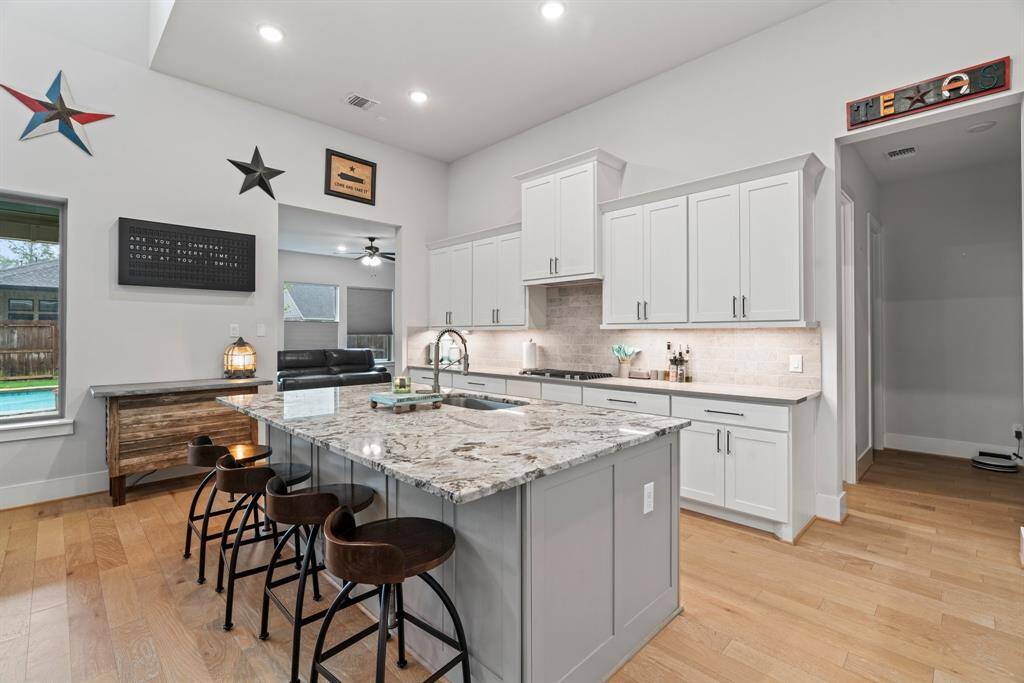 Gather ‘round the island! Oversized granite countertops to make this kitchen the ideal spot for casual meals and conversation.