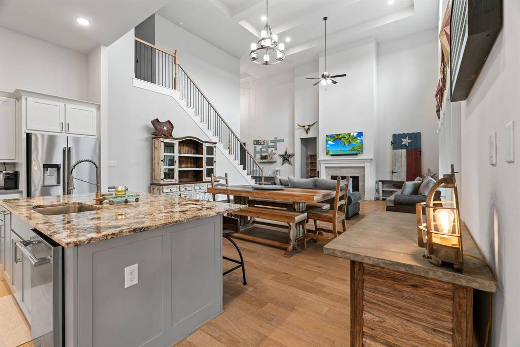 Open concept living at its finest. This angle showcases the home's spacious design, connecting kitchen, dining, and living room effortlessly.
