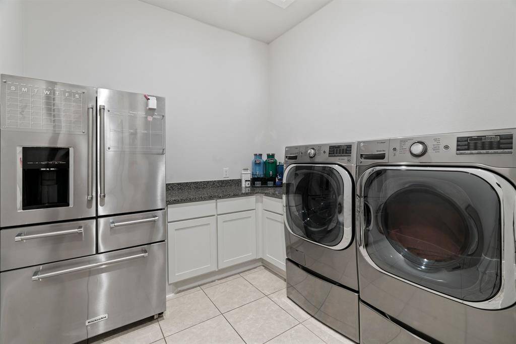 Laundry day made easy. With extra storage, granite folding space. This laundry room is both spacious and functional.