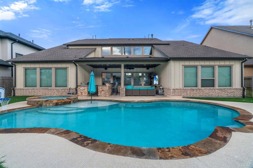 Outdoor OasisStep outside to your resort-style backyard featuring a heated pool and spa, perfect for year-round enjoymentExpansive covered patio for ultimate indoor-outdoor livingOutdoor kitchen with grill, sink, and bar—ideal for cookouts and entertaining. Firepit area for cozy evenings under the starsGenerac whole-home generator for peace of mind