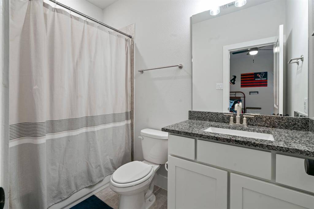 This thoughtfully designed en suite features a direct connection to the walk-in closet