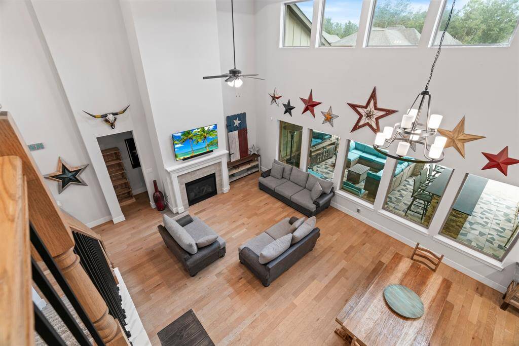 Light, bright, and beautifully designed. A stunning view from the staircase highlights the architectural lines and natural light of this showstopping living area.