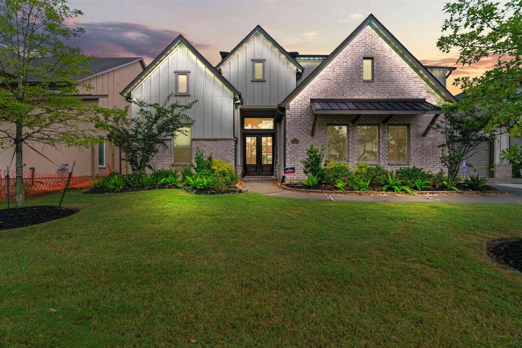 This home truly shines after sunset—warm exterior jelly fish lighting, elegant architecture, and a glowing backyard oasis set the perfect evening tone.