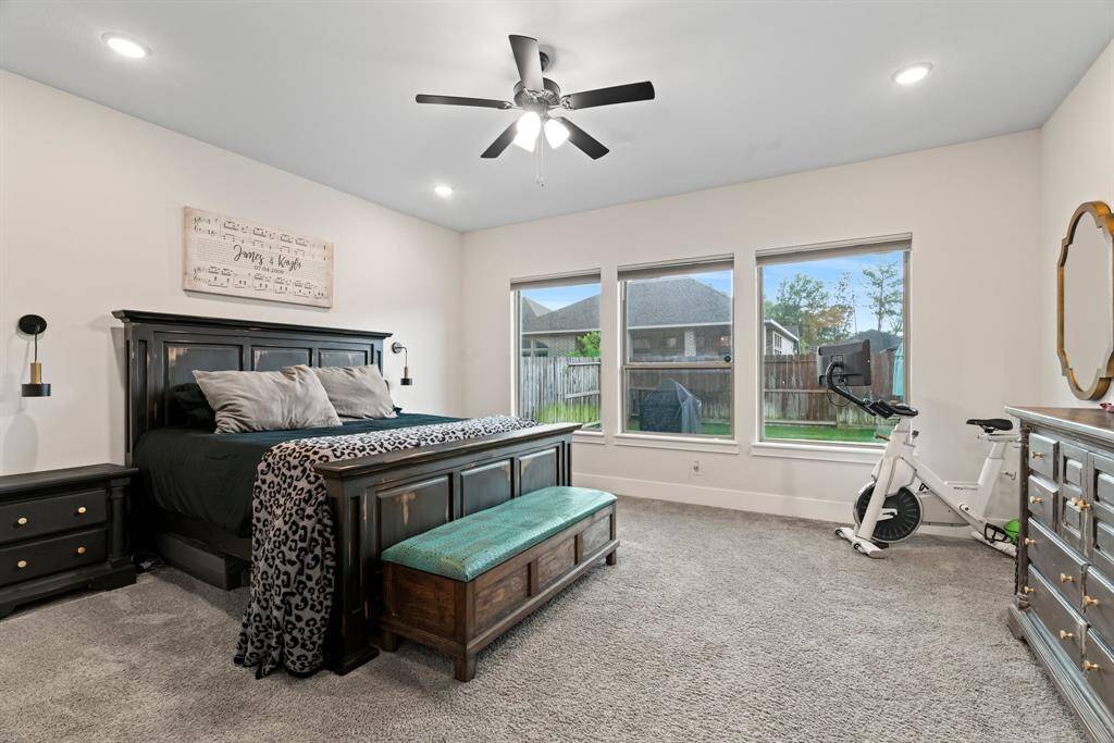Your private retreat awaits. The spacious primary suite features plush carpeting, serene natural light, and a peaceful layout designed for rest and relaxation.