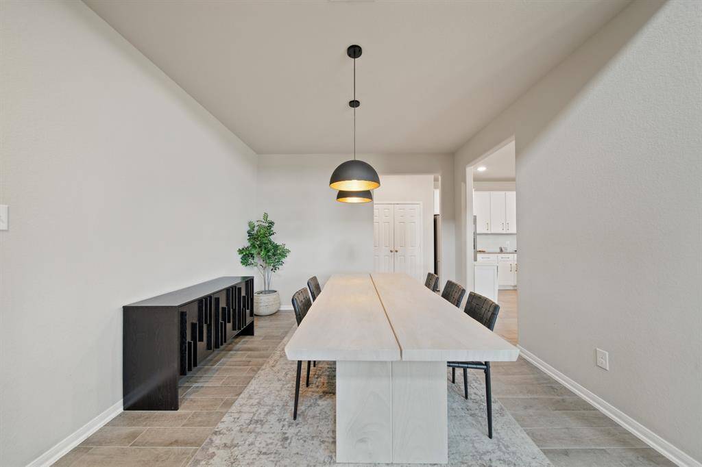 This amazing living room is spacious enough for the whole family, and features beautiful flooring and a view of the backyard through the large windows!