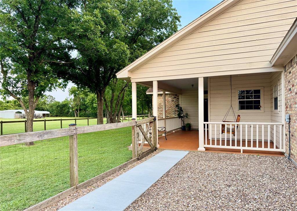 A brand new sidewalk surrounded by river rock was recently installed to access the porch to the primary residence.