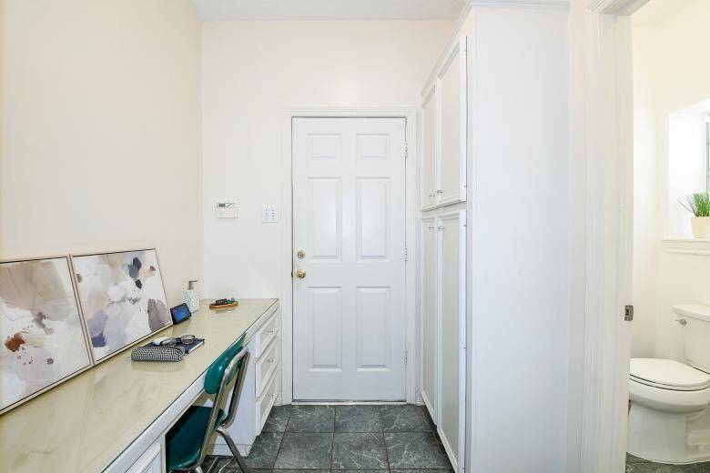As you walk towards the garage, you will find a built in desk area to your left and half bath to your right.