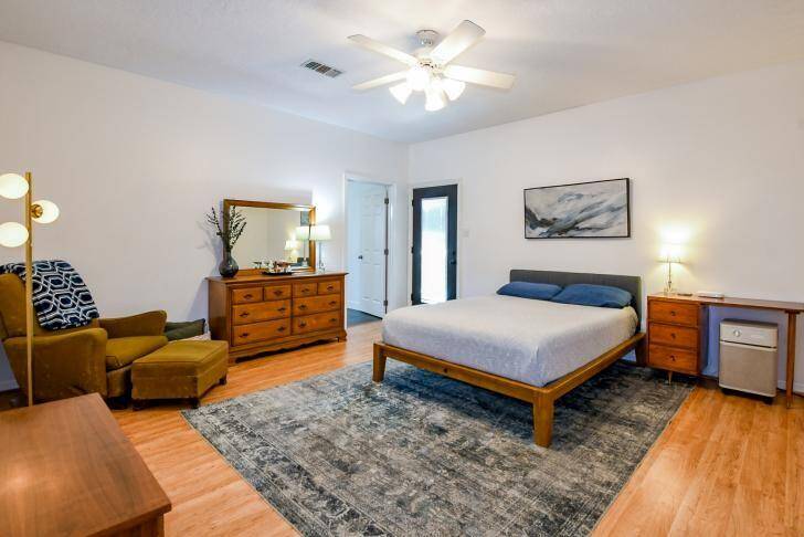 The primary bedroom (16x14) also has direct access to the covered back porch and brick patio—perfect for relaxing evenings by the fire pit with friends and family.