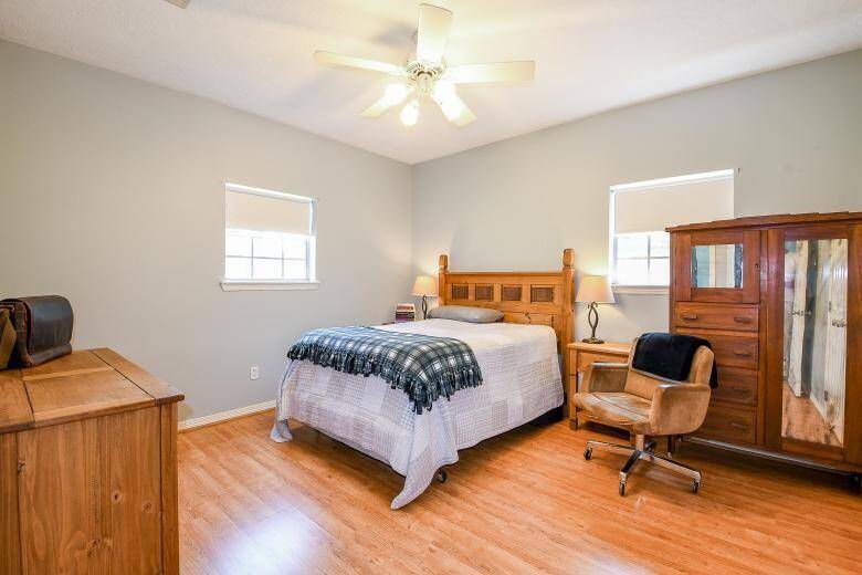 The third bedroom (13x12) has views of the side yard and goat pasture.