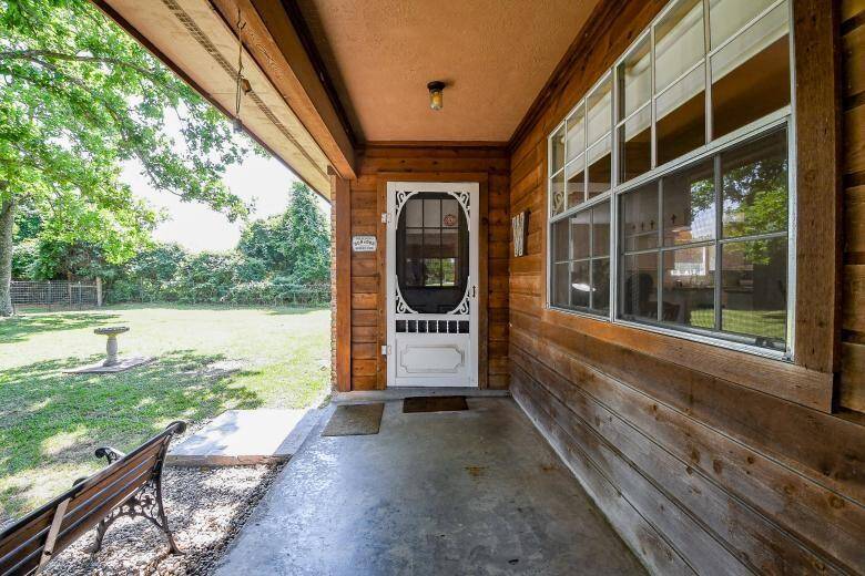 The entrance to the second residence exudes charm with a screen door and a recently painted front door.