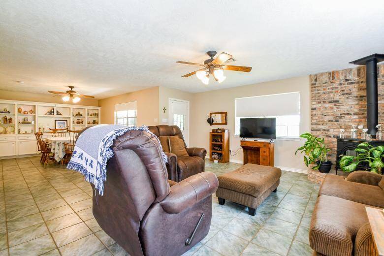 The living room has a lovely cast iron wood burning fireplace for cozy winter evenings.