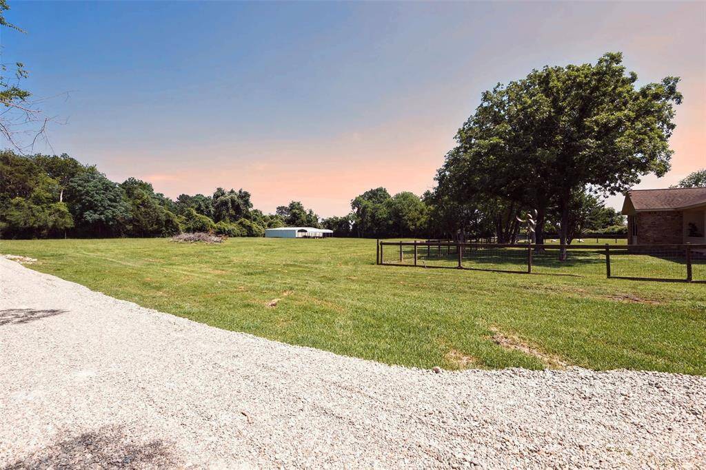 Large cleared portion of the 3.25 acres with the large metal building and carport, ready to set up your dream business