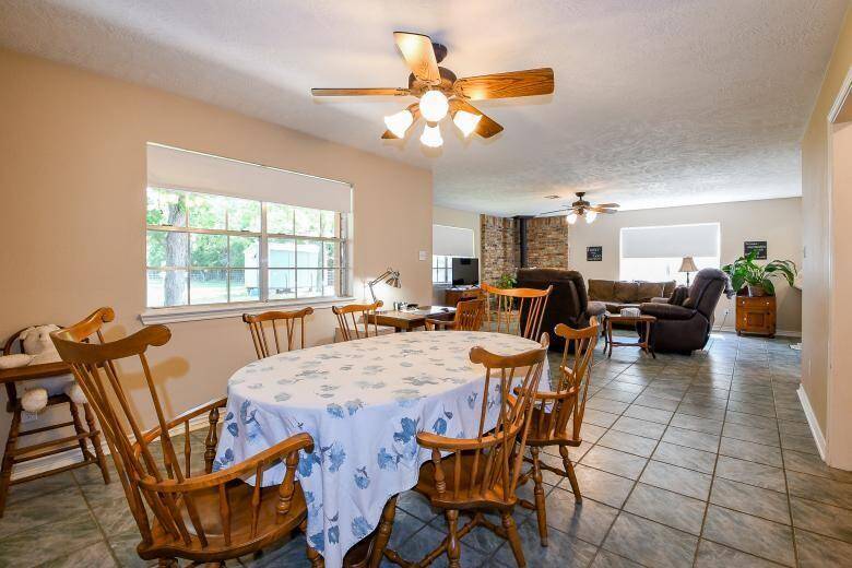 The dining area sits beside the living room and leads to the hallway with multiple hall closets for storage, 2 bedrooms, and 1 bathroom.