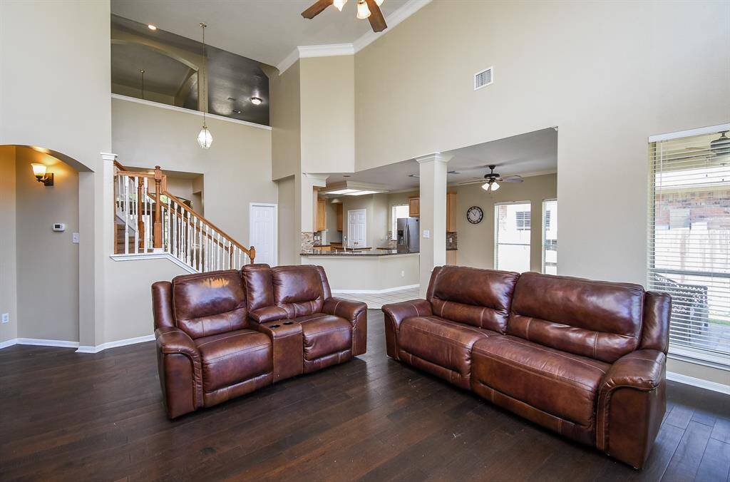 Spacious living room with high ceilings and plenty of natural light coming through the wall of windows.