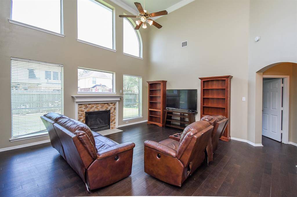 This photo showcases a spacious backyard with a well-maintained lawn and a brick exterior. The house features large windows and a patio area, perfect for outdoor entertaining.