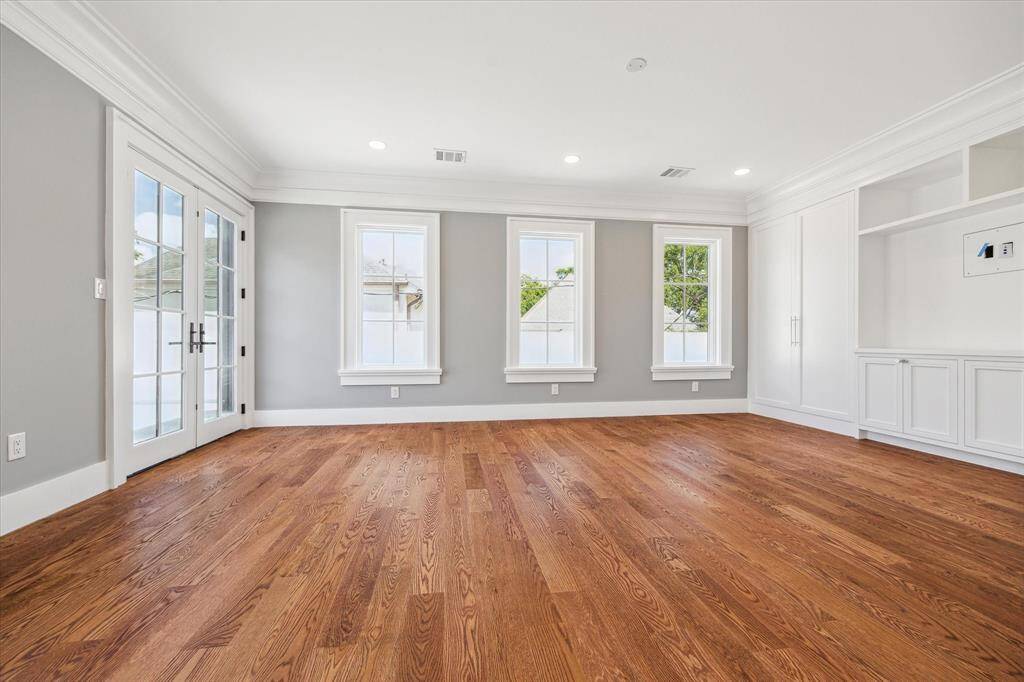 This secondary bedroom could also be used as a 2nd floor living area as it opens to the balcony!  There is built-in shelving and modern recessed lighting, creating an inviting atmosphere.
